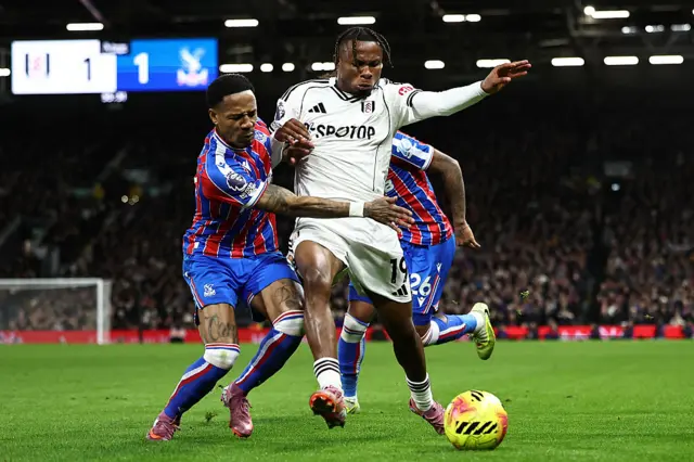 Fulham's Nigerian midfielder #19 Samuel Chukwueze (R) vies with Crystal Palace's English defender #17 Nathaniel Clyne (L) during the English Premier League football match between Fulham and Crystal Palace at Craven Cottage in London on December 7, 2025.