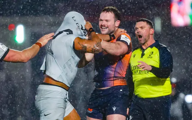 Ewan Ashman pulls Lewis Ludlam's shirt over his head in a shoving match