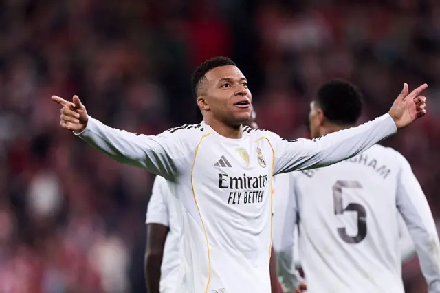 Real Madrid's Kylian Mbappe celebrates with his arms out wide