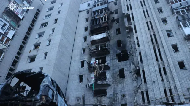 Damage to the tower block is seen in this image including black smoke marks and mangled balconies