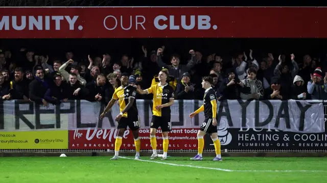 Tyrese Shade celebrates in front of the Burton fans