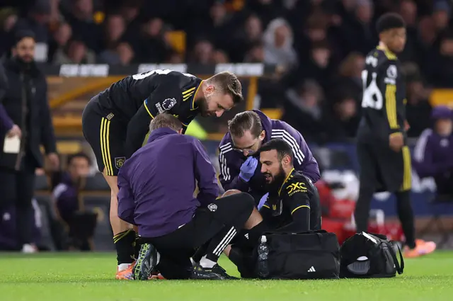 Noussair Mazraoui of Manchester United receives medical treatment during the Premier League match between Wolverhampton Wanderers and Manchester United at Molineux on December 08, 2025 in Wolverhampton, England.