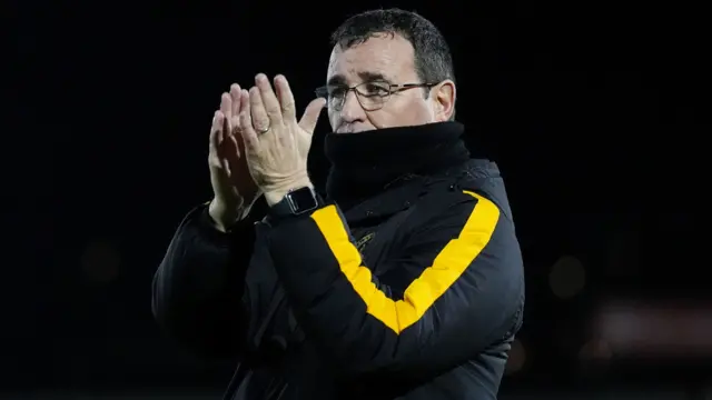 Burton manager Gary Bowyer claps the travelling support