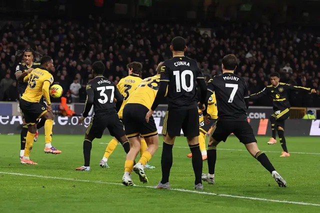 Yerson Mosquera of Wolverhampton Wanderers (L) is judged to have handled the ball after a VAR resulting in a yellow card and penalty kick during the Premier League match between Wolverhampton Wanderers and Manchester United at Molineux on December 08, 2025 in Wolverhampton, England.