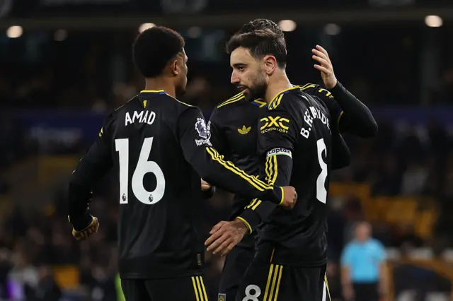 Bruno Fernandes of Manchester United celebrates scoring the fourth goal with Amad Diallo and Mason Mount of Manchester United during the Premier League match between Wolverhampton Wanderers and Manchester United at Molineux on December 08