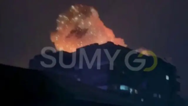 This screengrab from the verified video shows a large fireball erupting from close to the block of flats
