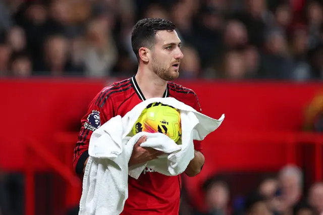 Diogo Dalot of Manchester United dries the ball with a towel during the Premier League match between Manchester United and West Ham United at Old Trafford on December 4, 2025 in Manchester, England.