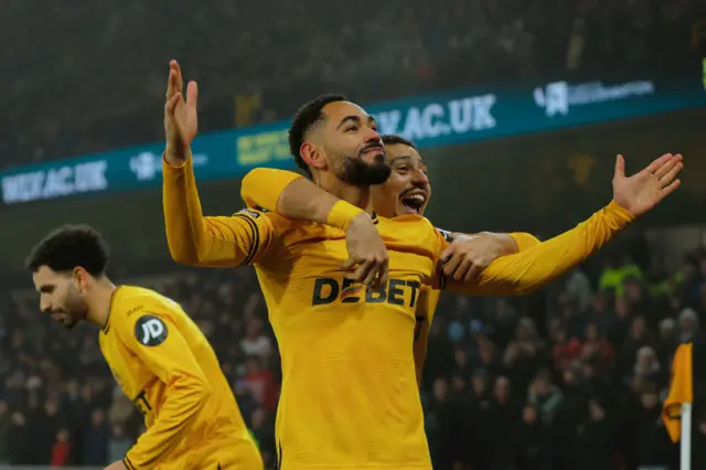 atheus Cunha of Wolverhampton Wanderers celebrates scoring the opening goal from a corner kick with Andre during the Premier League match between Wolverhampton Wanderers FC and Manchester United FC at Molineux on December 26, 2024 in Wolverhampton, England.