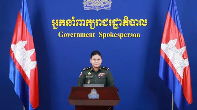 A woman wearing military uniform standing at a podium