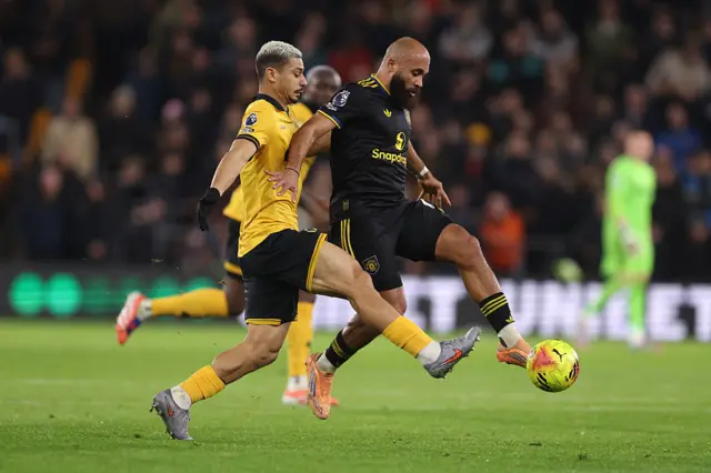 Bryan Mbeumo of Manchester United runs with the ball under pressure from Andre of Wolverhampton Wanderers during the Premier League match between Wolverhampton Wanderers and Manchester United at Molineux on December 08, 2025