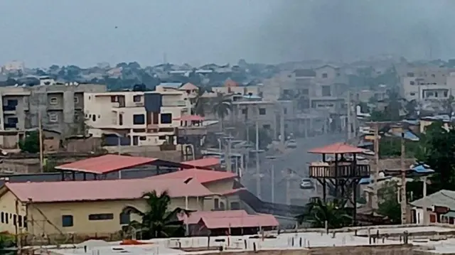 A screengrab from one video showing smoke rising over Cotonou