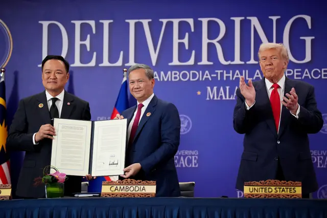 Thai Prime Minister Anutin Charnvirakul and Cambodian Prime Minister Hun Manet shake hands following the signing of a Cambodia-Thailand peace deal