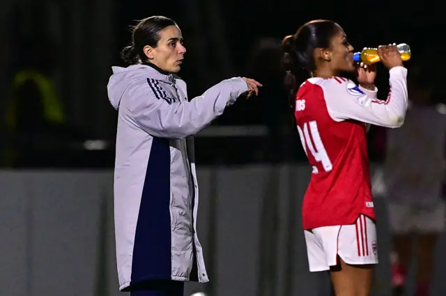 Arsenal's Dutch interim head coach Renee Slegers (L) gestures on the touchline during the UEFA Women's Champions League, league phase football match between Arsenal and FC Twente at Meadow Park