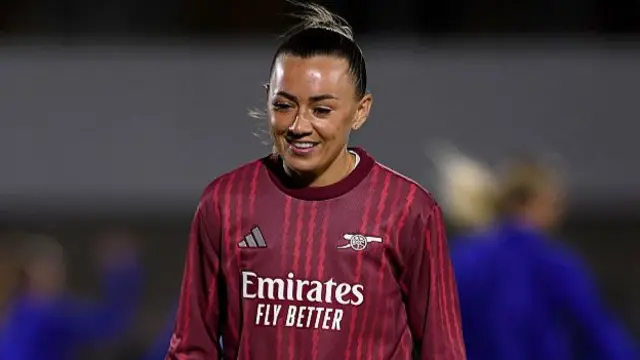 Katie McCabe smiles in the warm up