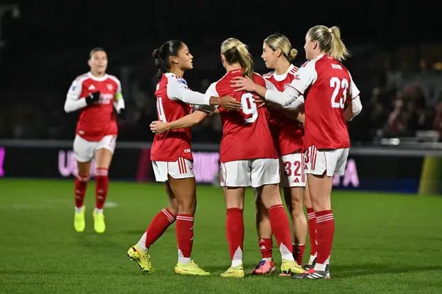 Arsenal's English striker #09 Beth Mead celebrates with teammates after scoring the opening goal of the UEFA Women's Champions League, league phase football match between Arsenal and FC Twente at Meadow Park, in Borehamwood, north of London on December 9, 2025.