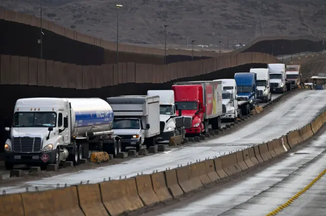 Tractor trailers wait in line on the US-Mexico border in Tijuana, Baja California, Mexico