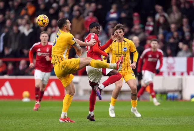 Dunk and Elanga duel for the ball as O'Riley watches on