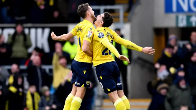 Will Vaulks and Ruben Rodrigues chest bump in mid-air after Greg Leigh's goal against Bristol City