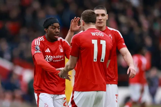 Elanga and Wood celebrate with a low five after combining for a goal