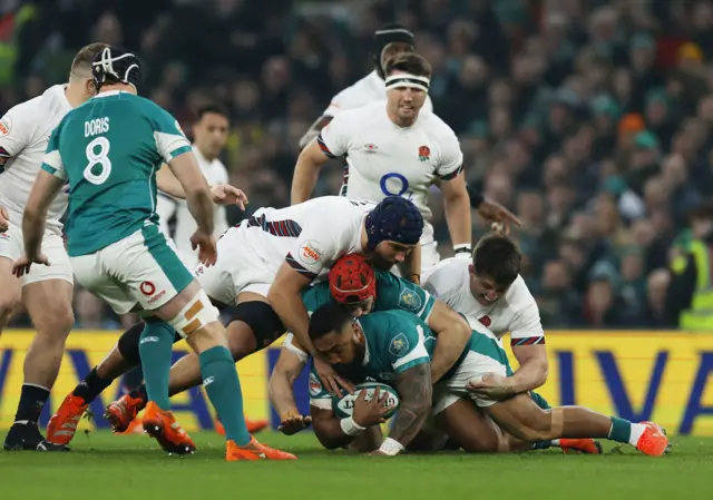 Ireland's Bundee Aki in action with Ireland's Josh van der Flier and England's George Martin