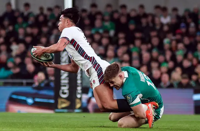 England's Marcus Smith is tackled by Ireland's Garry Ringrose