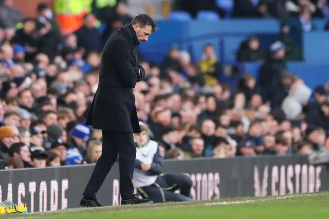 Van Nistelrooy stands on the touchline staring at the floor