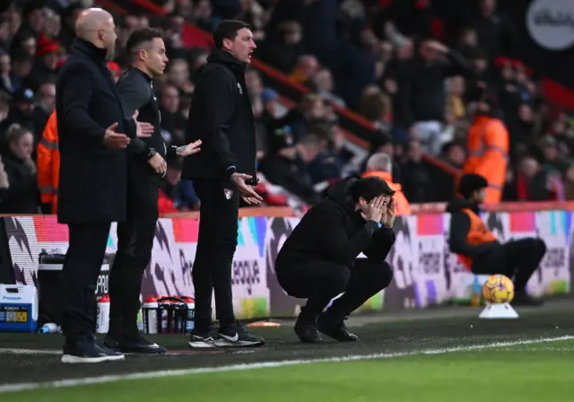 Iraola kneels with his hands to his head