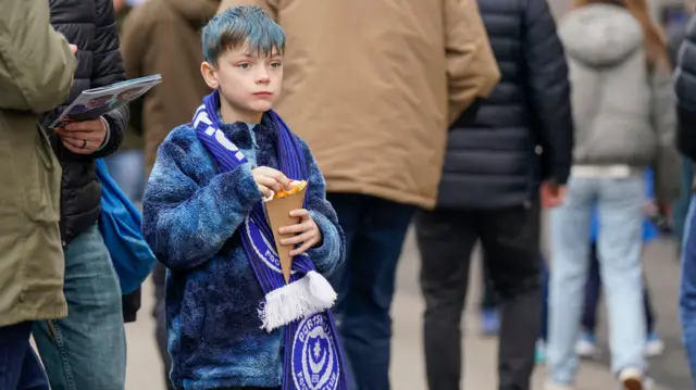 A young Portsmouth fan outside Fratton Park