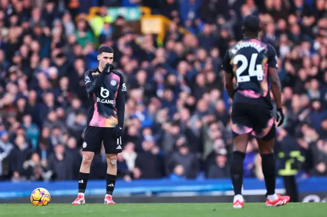 Leicester players stand stunned as they wait to kick off again