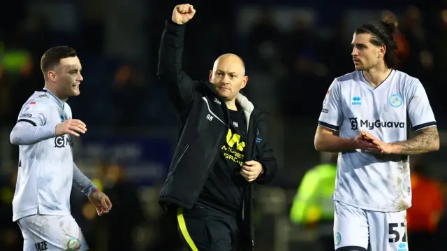 Alex Neil celebrates with his players after Millwall beat Portsmouth