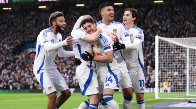 Leeds players celebrate with Manor Solomon