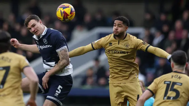 Jonathan Varane challenges for a ball for QPR