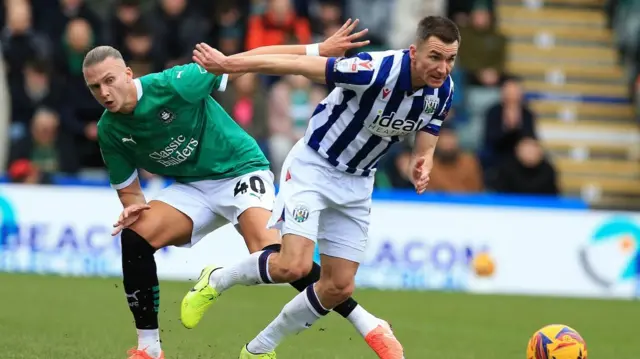 West Brom's Jed Wallace dribbles away from Plymouth's Maksym Talovierov