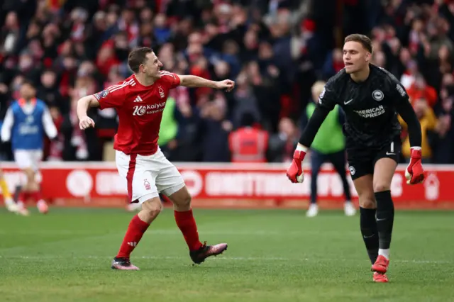 Wood celebrates his third goal as Verbruggen drags himself off the floor