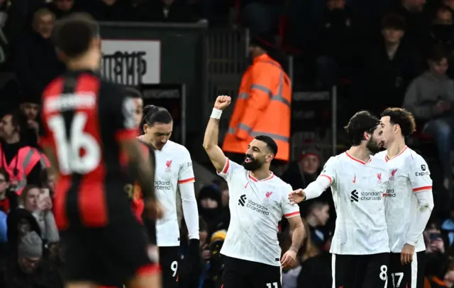 Salah holds his fist to the sky in celebration