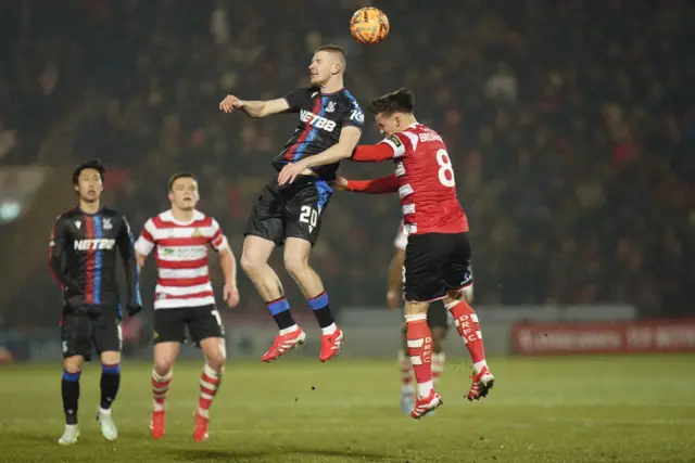 Crystal Palace's Adam Wharton (left) and Doncaster Rovers' George Broadbent battle for the ball.