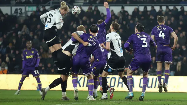 Derby County's Lars-Jorgen Salvesen attempts a header at the Oxford goal