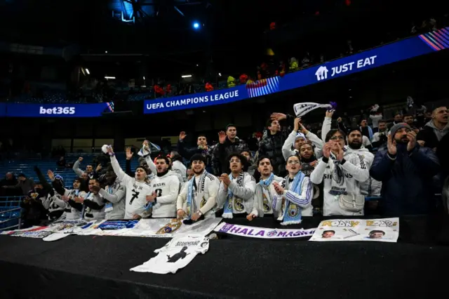 Madrid fans sing and wave scarves