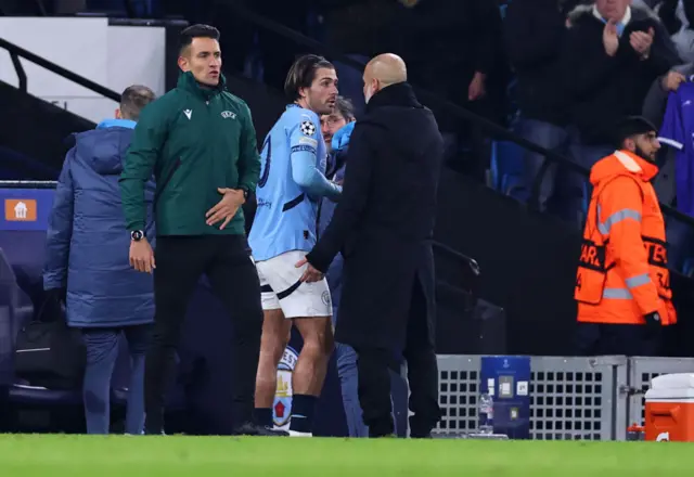 Grealish and Guardiola chat after the midfielder is forced off with an injury