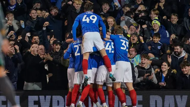 Portsmouth players celebrate their second goal against Cardiff