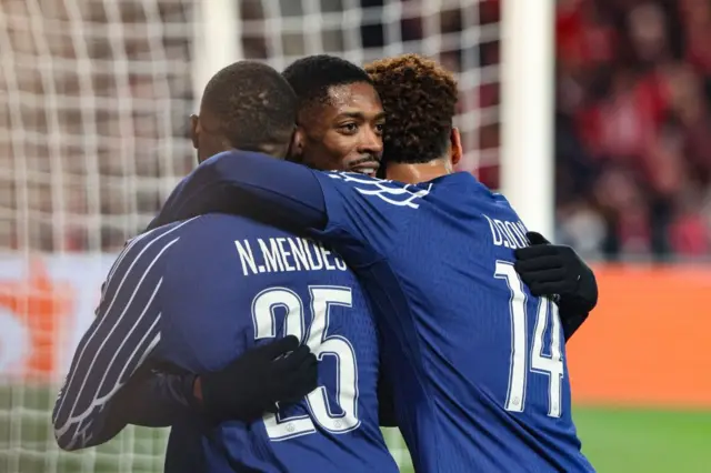 Dembele hugs Mendes and Doue after his goal