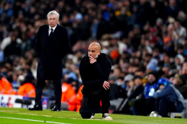 Guardiola kneels on the touchline as Madrid celebrate