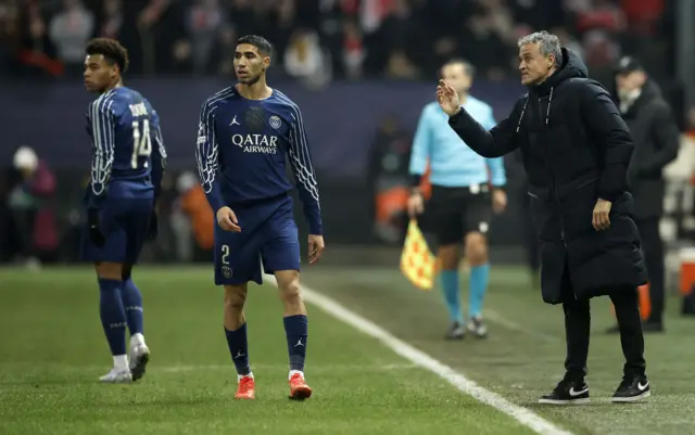 Hakimi walks away as Enrique gives instructions on the touchline