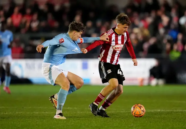 Exeter City's Jake Thomas Richards (right) and Nottingham Forest's Ryan Yates (left) battle for the ball during the Emirates FA Cup fourth round match at St James Park, Exeter.