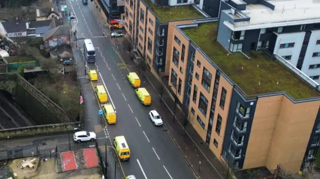 Police vehicles line a street