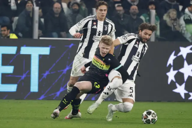 Juventus and PSV players battle for the ball