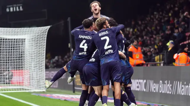 Joe Rodon screams in celebration as his team-mates mob goalscorer Joel Piroe