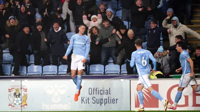 Bobby Thomas leaps into the air in front of the Coventry fans after scoring against QPR