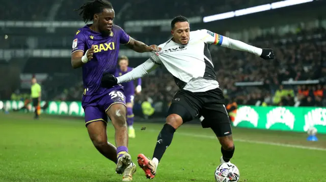 Derby forward Nathaniel Mendez-Laing tries to find a way past Oxford's Peter Kioso