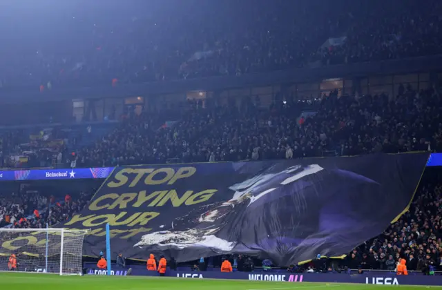 Rodri tribute banner by City fans reading 'Stop Crying Your Heart Out'